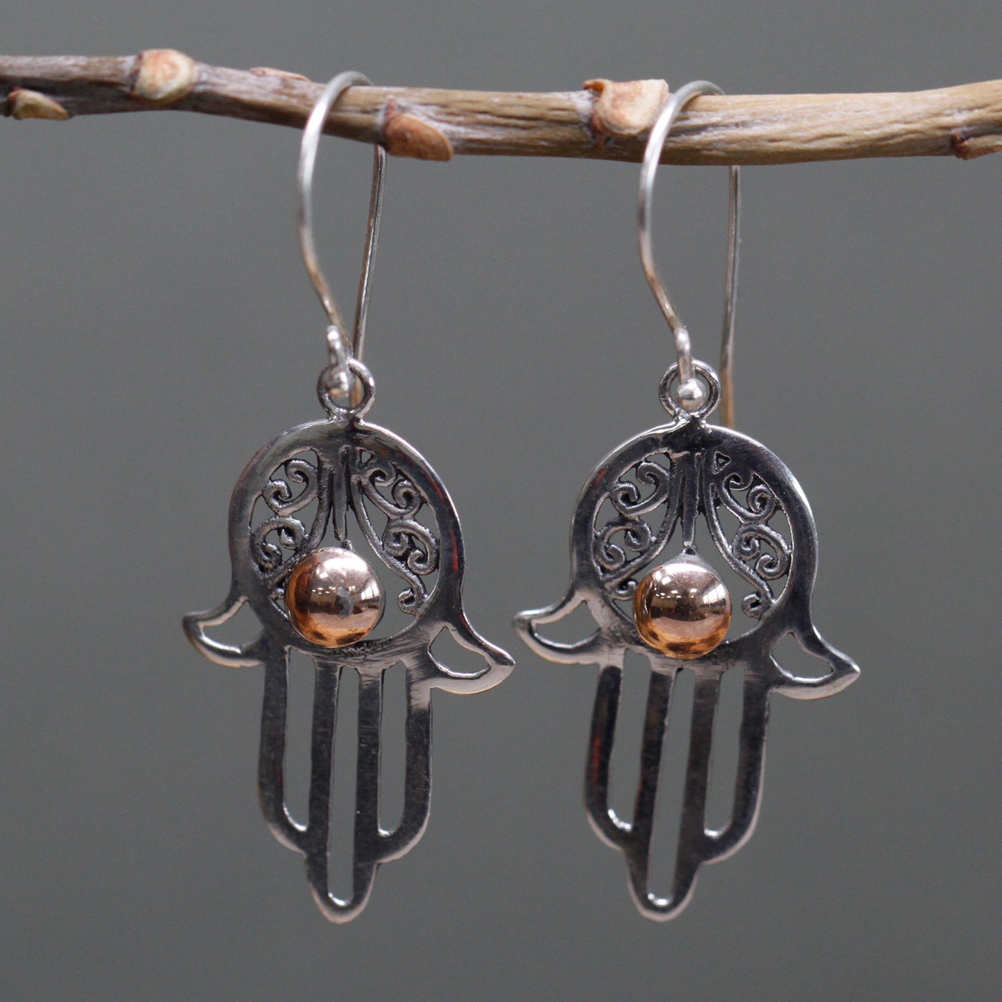 Silver Hamsa earrings featuring intricate design, perfect for gifts that inspire confidence and style.