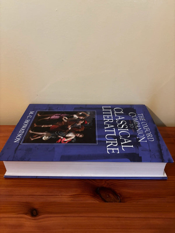 The Oxford Companion to Classical Literature by M C Howatson displayed on a wooden surface, perfect for literature enthusiasts.
