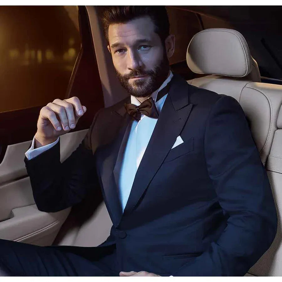 Sophisticated man wearing a tuxedo, embodying confidence, ideal for Avon Black Suede EDT for Him fragrance.