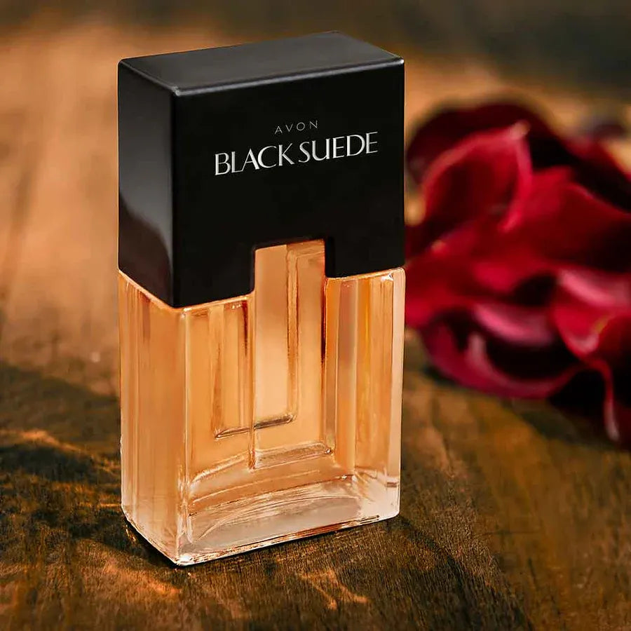 Avon Black Suede EDT for Him showcased in a stylish 75ml bottle on a wooden surface with rose petals.
