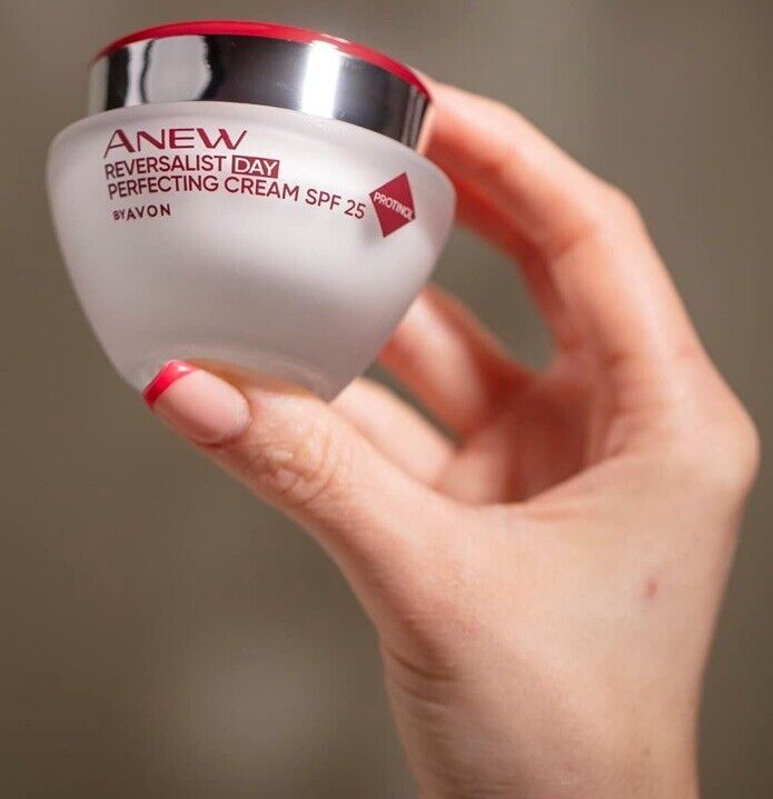 Avon Anew Reversalist Day Perfecting Cream in hand, showcasing its age-defying formula for revitalised skin.
