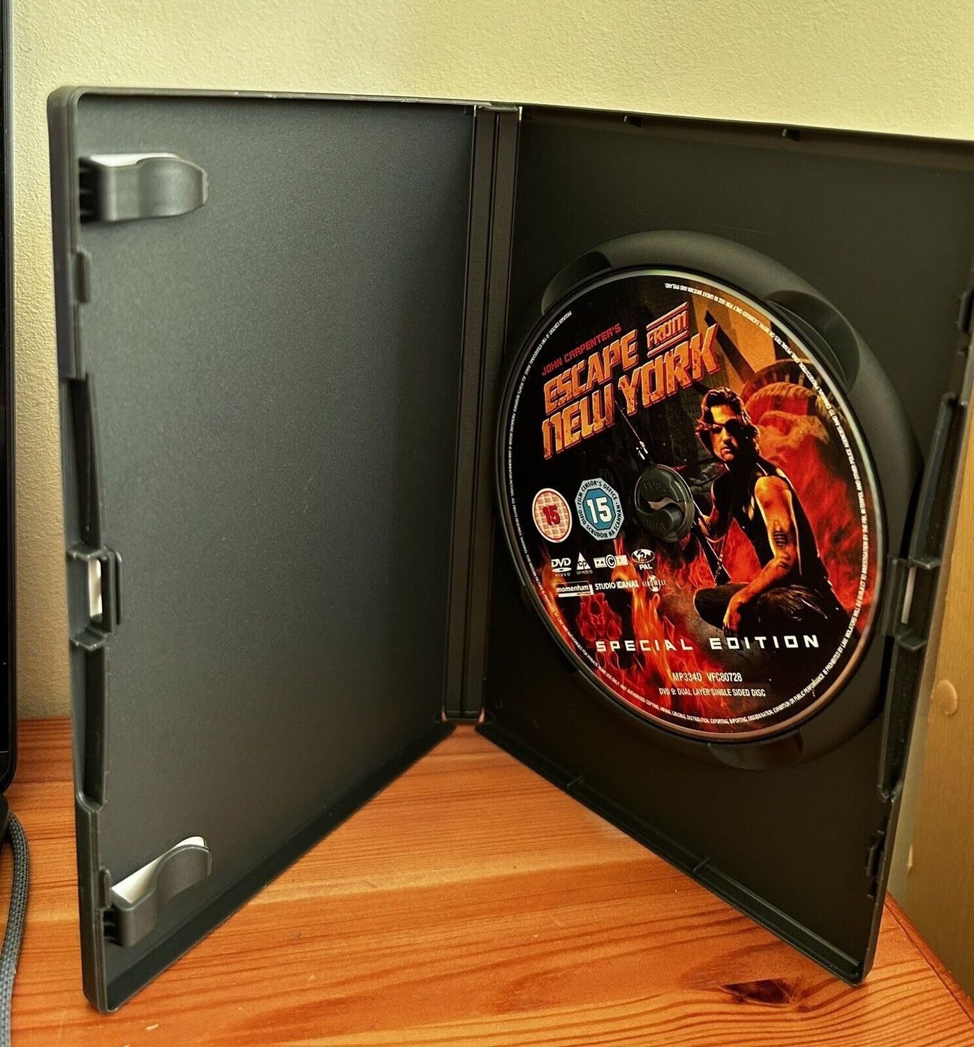 Escape From New York (DVD) displayed in a case, featuring stunning artwork from the cult classic film.