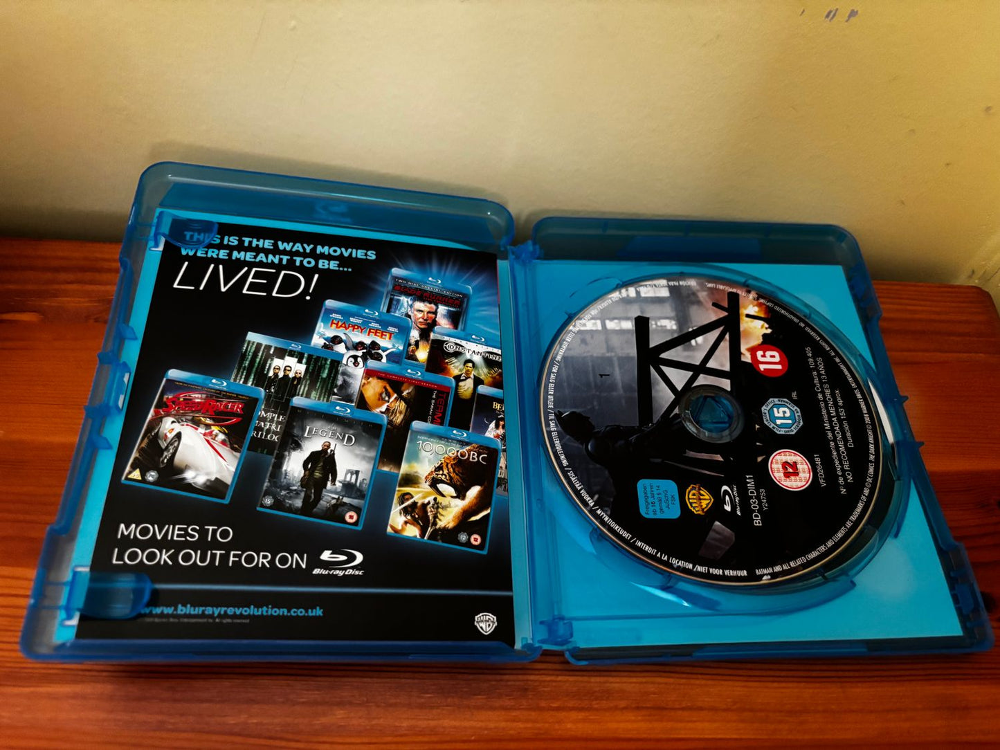 The Dark Knight Blu Ray displayed inside its case, showcasing the iconic film's thrilling content and extras.