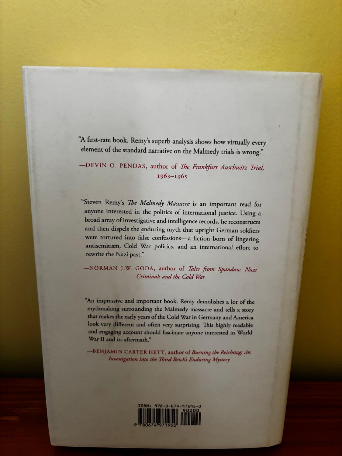 Explore the back cover of The Malmedy Massacre (Hardback), detailing its insights on war crimes and justice.