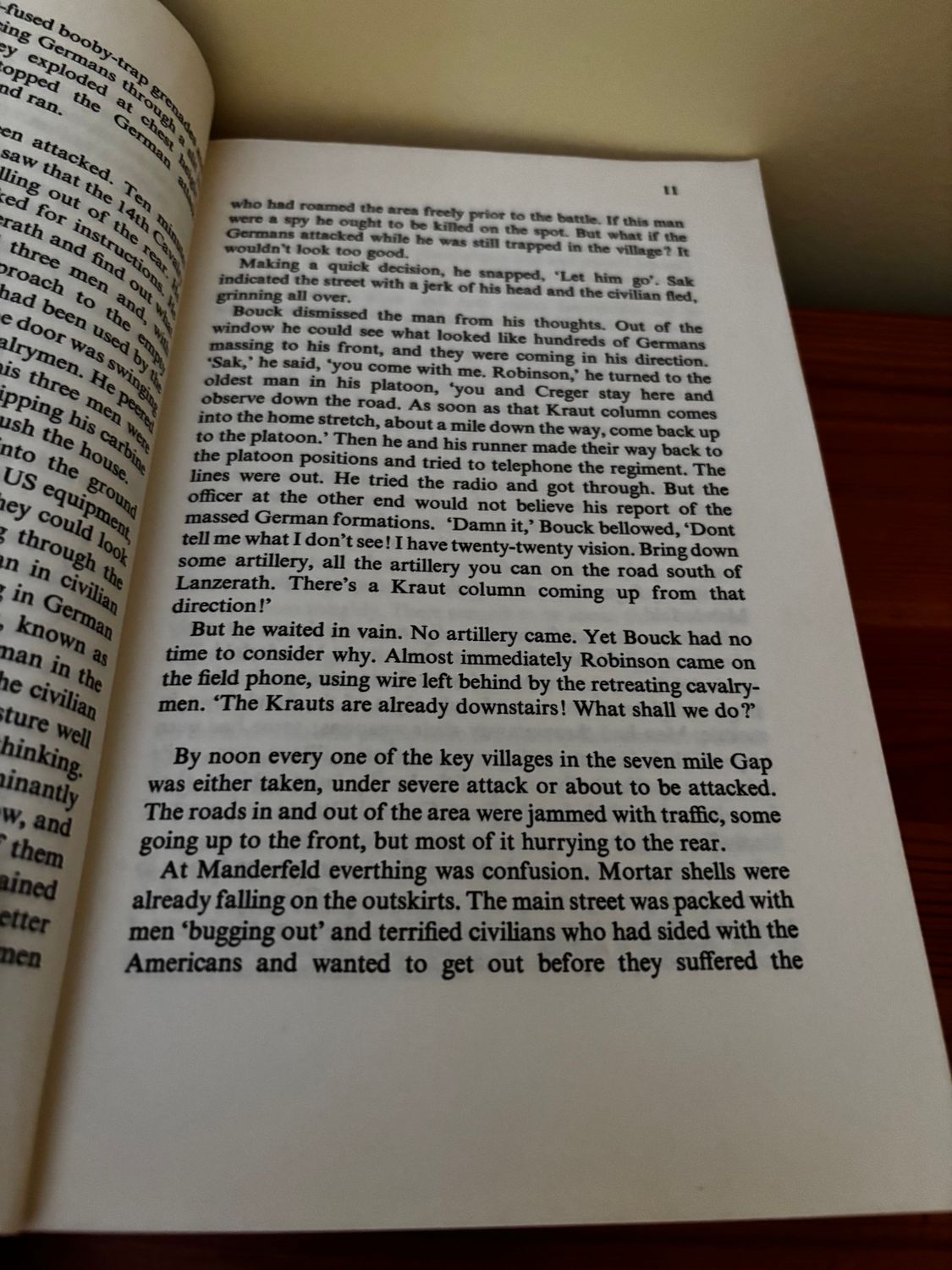 Detailed text from the Massacre at Malmedy (Pen & Sword paperback) reveals WWII's tragic events, published by Pen & Sword Books Ltd.