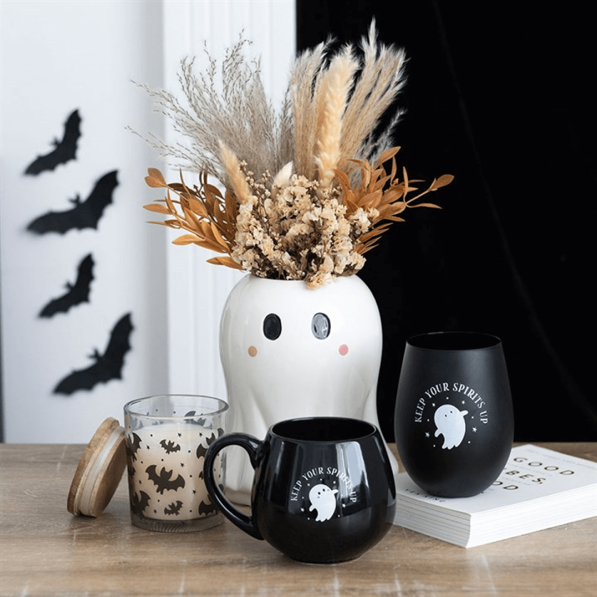 Keep Your Spirits Up stemless ghost glass with ghost print, beside a black mug and white ghost vase.