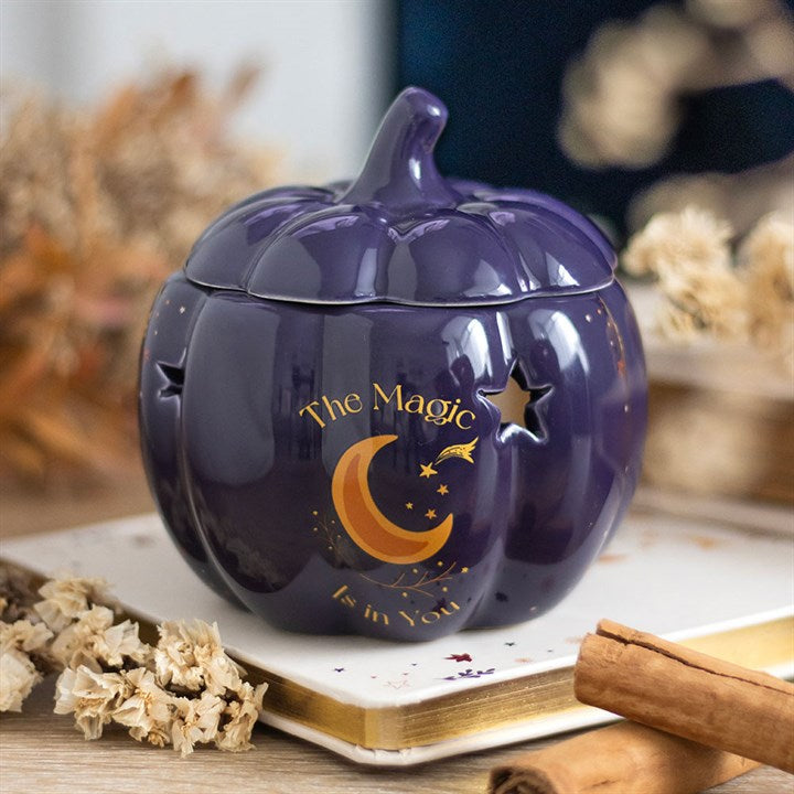 The Magic Is in You Pumpkin Oil Burner, a midnight-blue ceramic piece with golden stars, perfect for autumn ambience.