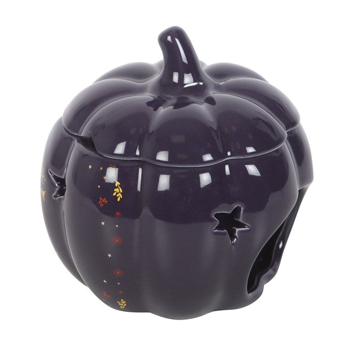 The Magic Is in You Pumpkin Oil Burner features a midnight-blue ceramic design with golden stars for a magical ambience.