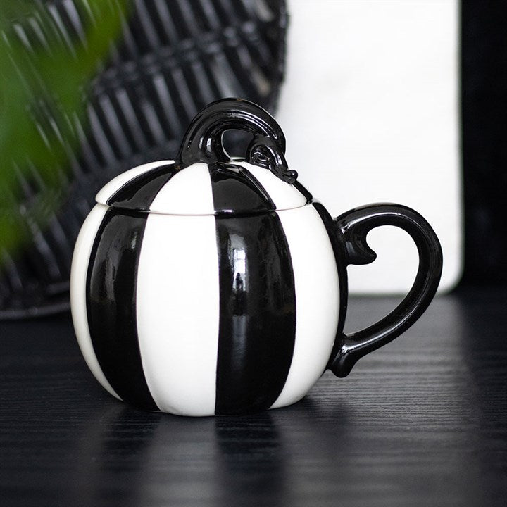 Stylishly sip from the Black and White Striped Pumpkin Lidded Mug, perfect for cosy gatherings and hot drinks.