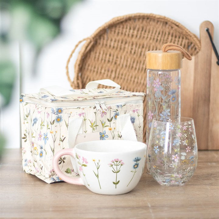 Blooming Lovely Floral Lunch Bag nestled beside a cup and water bottle, showcasing a delightful floral design.