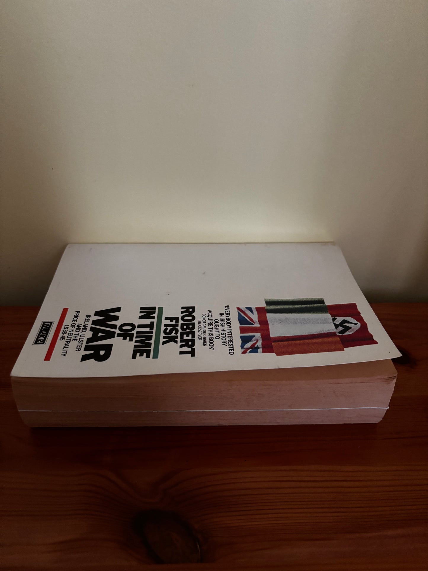 In Time of War: Ireland, Ulster and the Price of Neutrality, 1939-45 paperback displayed on a wooden surface.