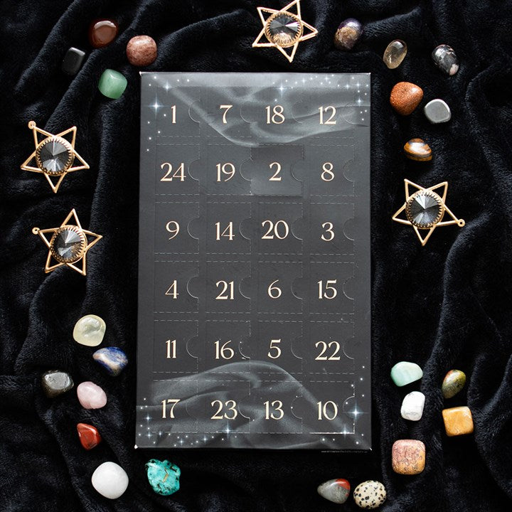 24-Day Crystal Advent Calendar displays 24 doors, surrounded by tumbled gemstones for spiritual healing this Christmas.