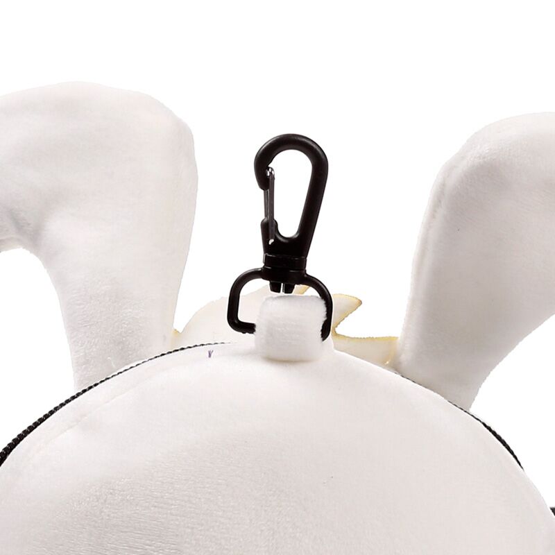 Close-up of a black clip attached to a white Idefix (Dogmatix) plush ear from Relaxeazzz Travel Pillow & Eye Mask set.