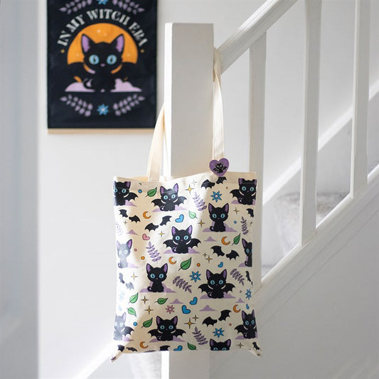 Cute and Creepy Cat Print Polycotton Tote Bag with Enamel Pin, featuring playful black cats and bat wings for spooky style.
