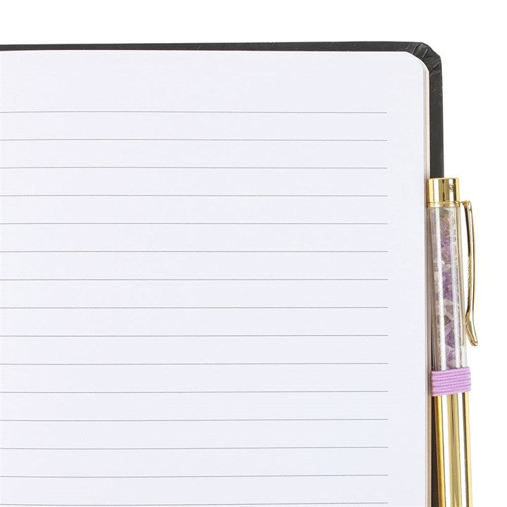 Open A5 notebook with lined pages, featuring 'In My Witch Era' and an amethyst pen for magical notes.