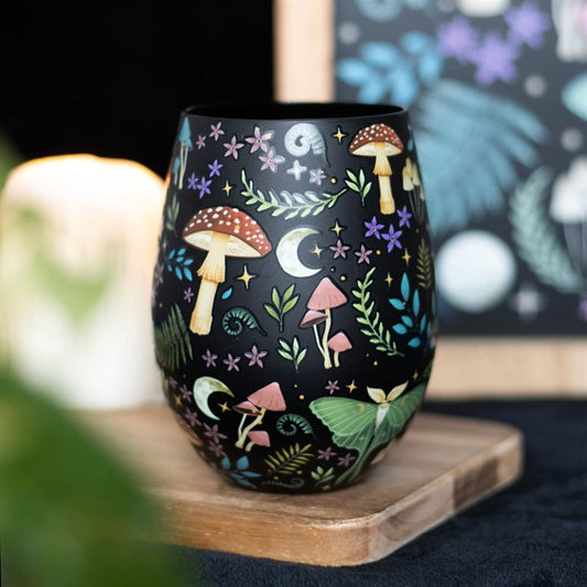 Dark Forest Print stemless glass featuring a night forest scene with toadstools, luna moths, florals and moonlit stars.