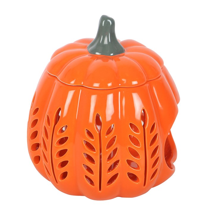 Bright orange pumpkin oil burner and wax warmer with leaf cut-outs, perfect for autumn evenings. Orange Leaf Cut Out Pumpkin Oil Burner and Wax Warmer.