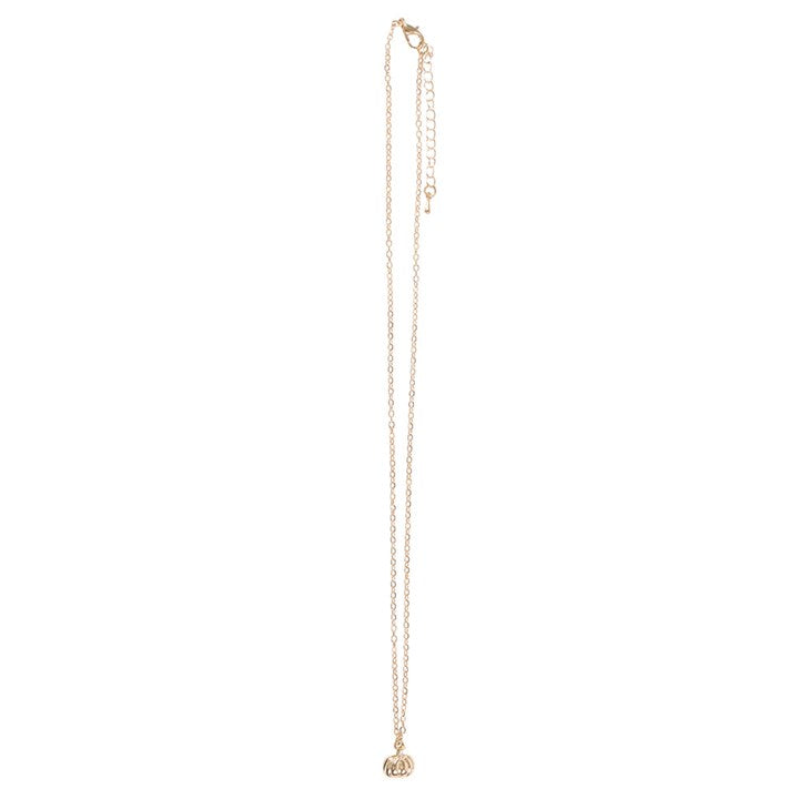 Gold-toned pumpkin pendant necklace on a long chain, with a matching greeting card and envelope.