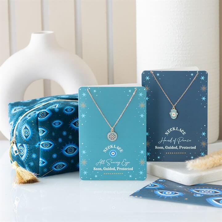 All Seeing Eye Print Velvet Makeup Bag in dark blue with eye motif, stars and a gold tassel.