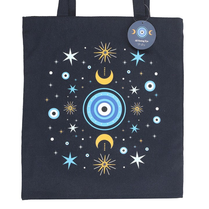 Dark blue All Seeing Eye Polycotton Tote Bag adorned with moons and stars, perfect for errands or thoughtful gifts.