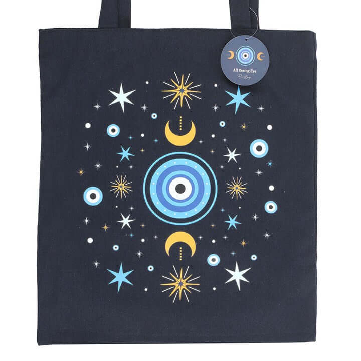 Dark blue All Seeing Eye Polycotton Tote Bag adorned with moons and stars, perfect for errands or thoughtful gifts.