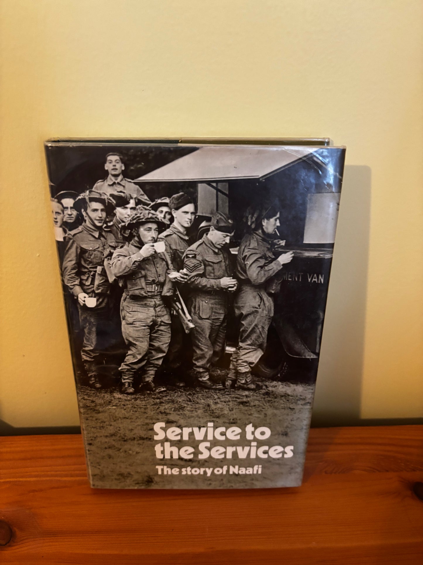 Hardcover book "Service to the services: The story of Naafi Hardcover – 1 Jan. 1971" showcasing military history.