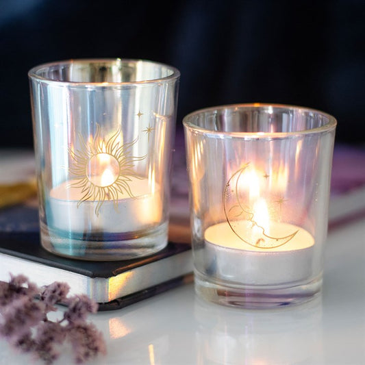 Iridescent Sun and Moon Votive Candle Holders: glass tealight holders with sun and moon designs and lit candles.