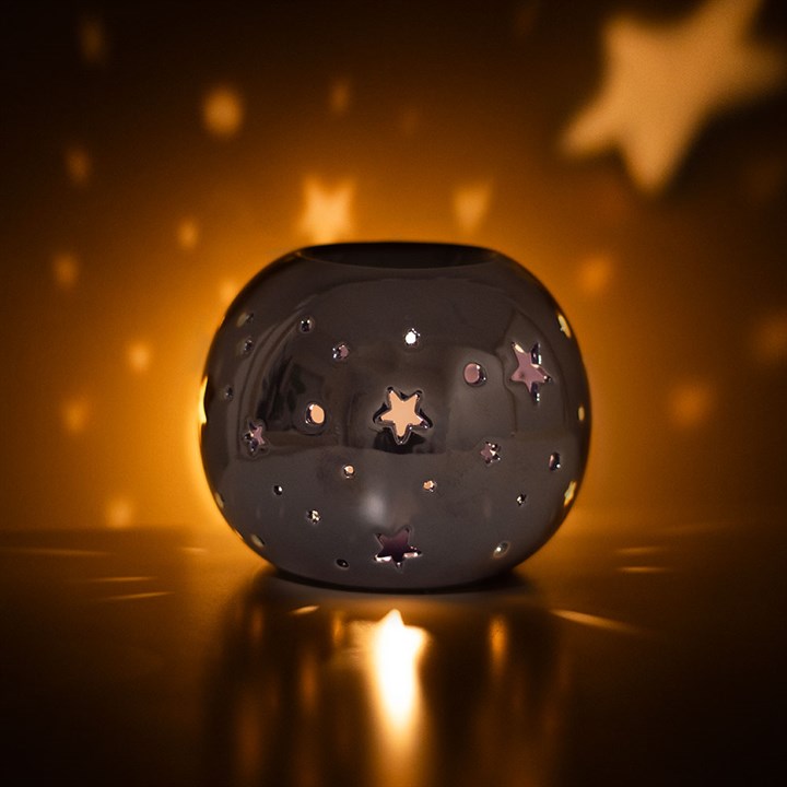 Purple Iridescent Star Oil Burner and Wax Warmer casts a magical glow with star cut-outs, adding whimsy to any space.