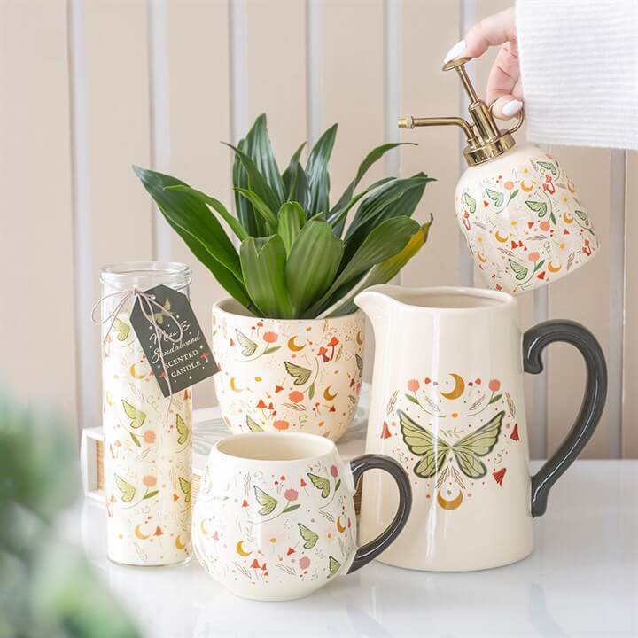 Fairy Folklore Print Moss - Moss & Sandalwood Tube Candle in cosy home decor with plant pot and mug.