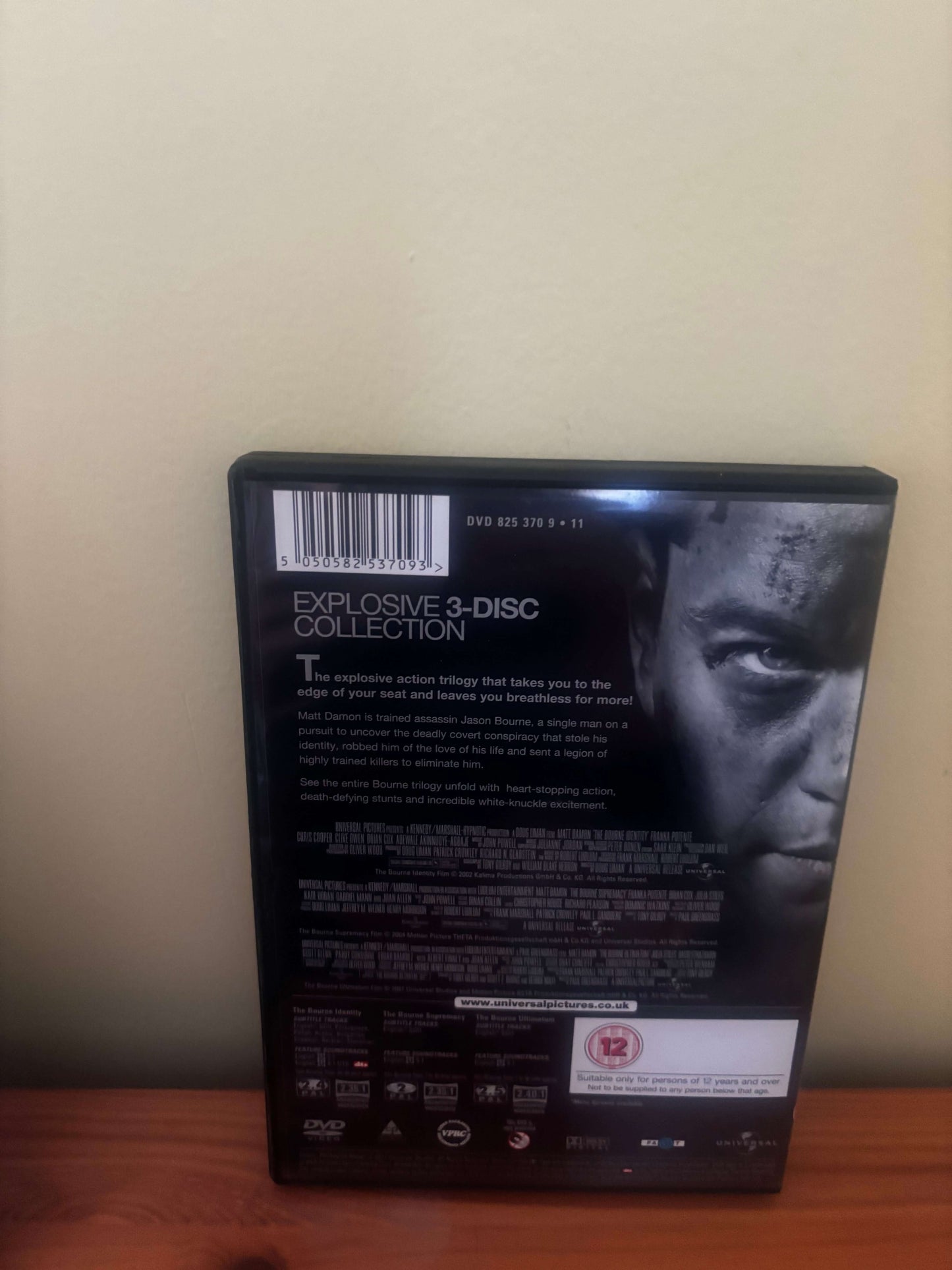 DVD box with a person's face on the cover against a beige wall.