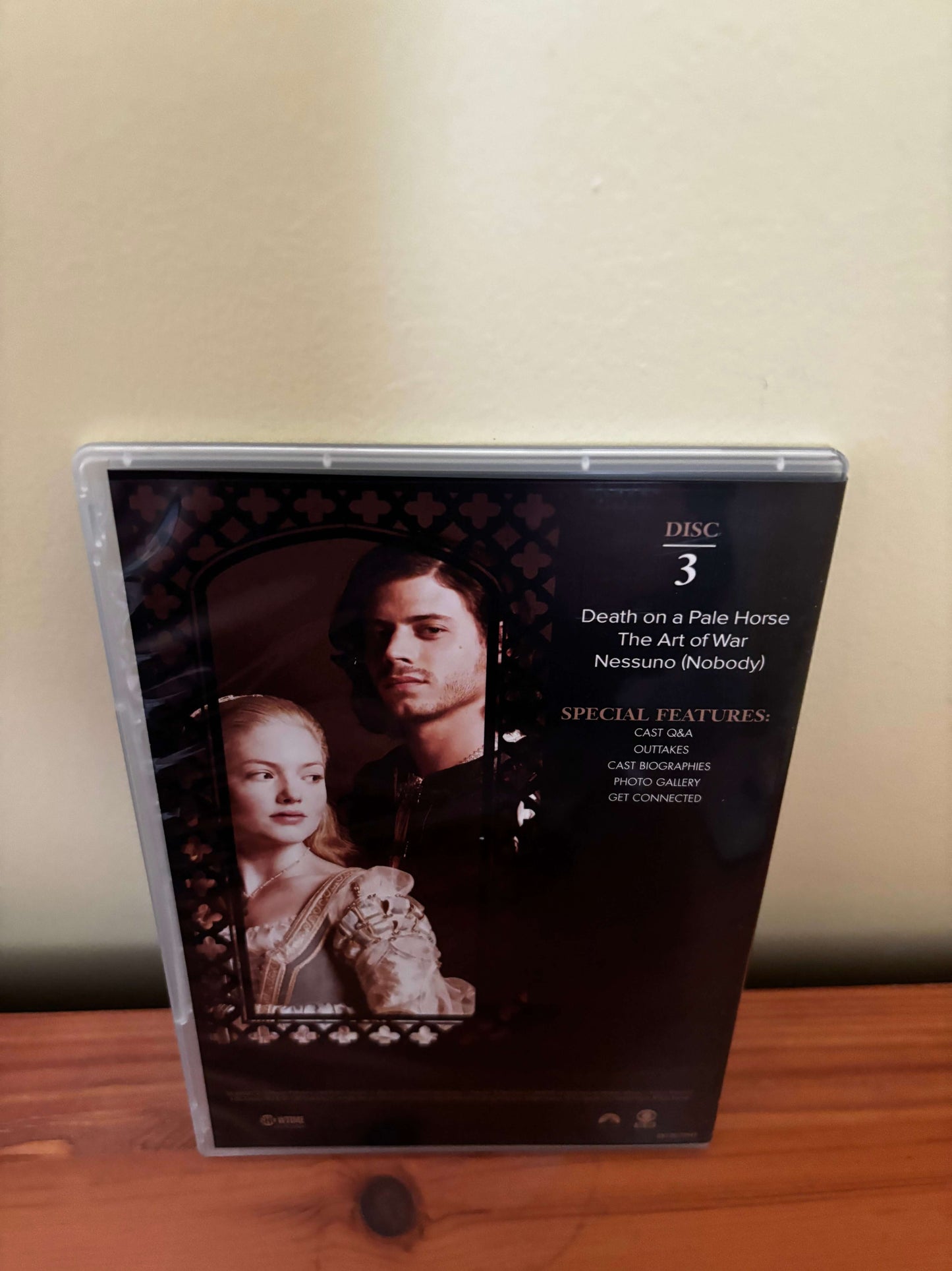 DVD case with images of people on a wooden surface