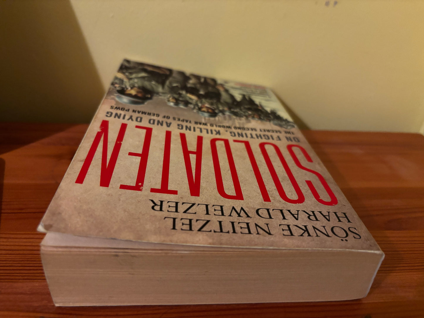 Paperback cover of Soldaten: On Fighting, Killing and Dying, German POWs, on a wooden table.