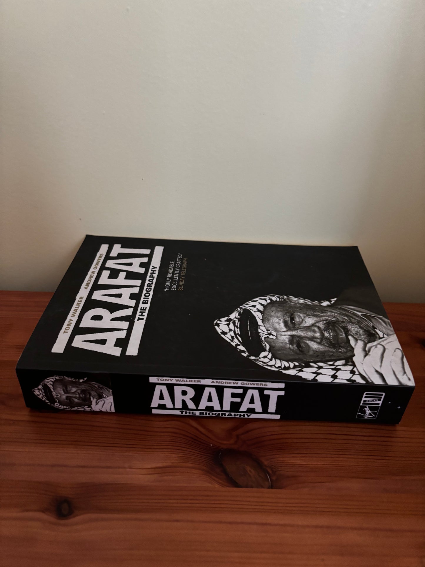Discover the gripping narrative in "Arafat: The Biography By Tony Walker - Insightful Read" on a wooden table.
