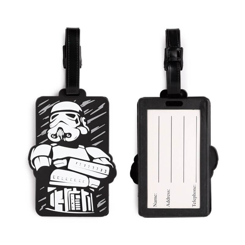 PVC luggage tag with Stormtrooper illustration on black background; strap; back shows name, address and telephone.