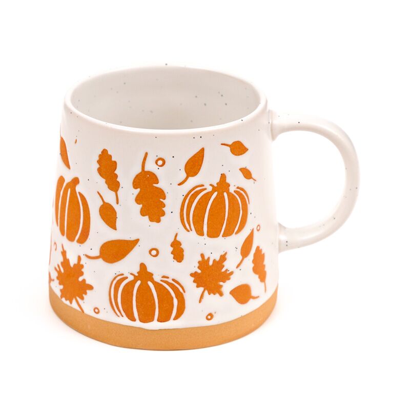 Stoneware Pumpkin Mug with orange pumpkins, leaves and a tan base on white ceramic.