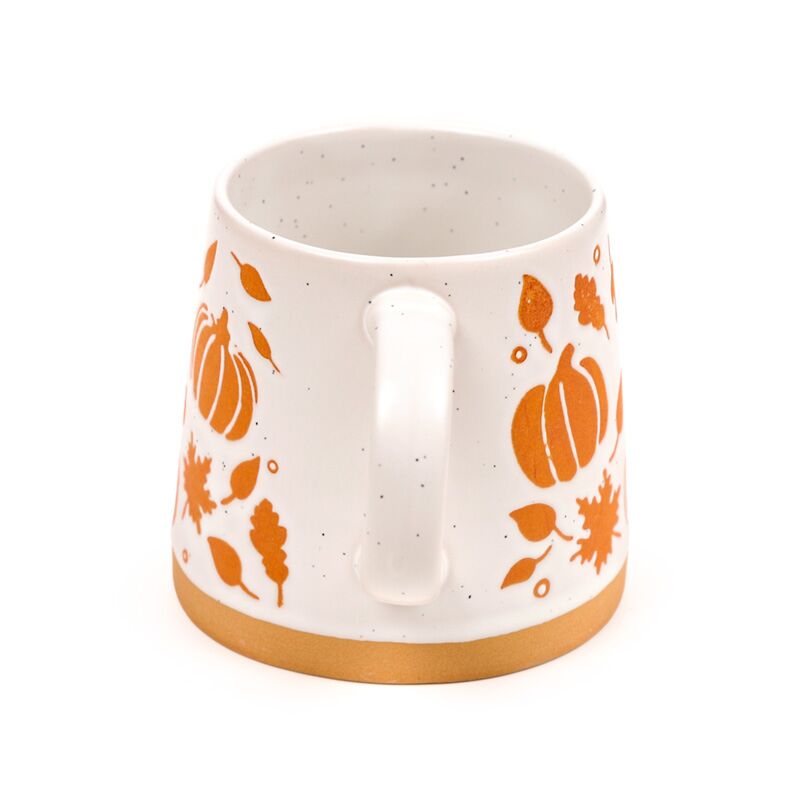 Stoneware mug with pumpkin pattern featuring orange pumpkins and leaves on speckled ceramic, copper-coloured base.