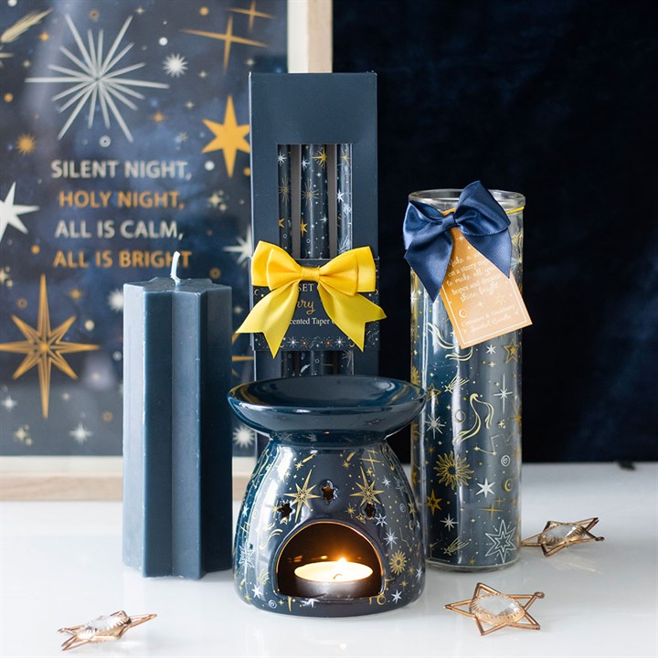 Starry Night Cinnamon tube candle alongside celestial décor, perfect for festive and everyday settings.