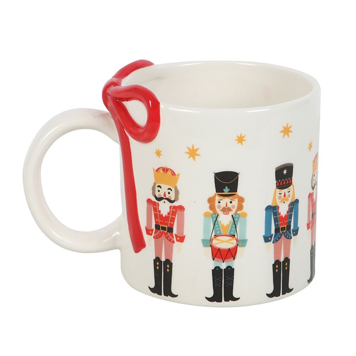 Festive Nutcracker Print Mug with Bow, perfect for cosy drinks by the fire this winter season. Ideal for hot chocolate lovers.