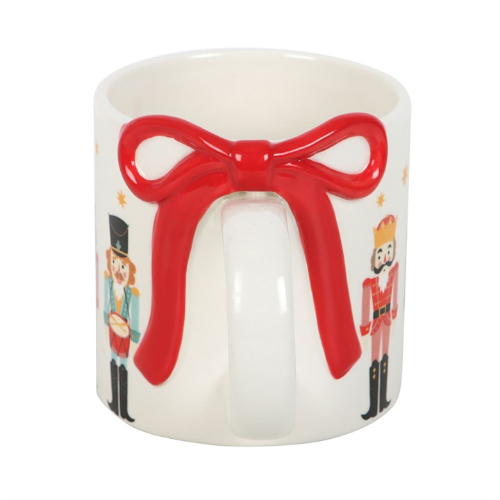 Festive Nutcracker Print Mug with Bow, perfect for cozy drinks by the fire this winter season. Ideal for tea or hot chocolate.