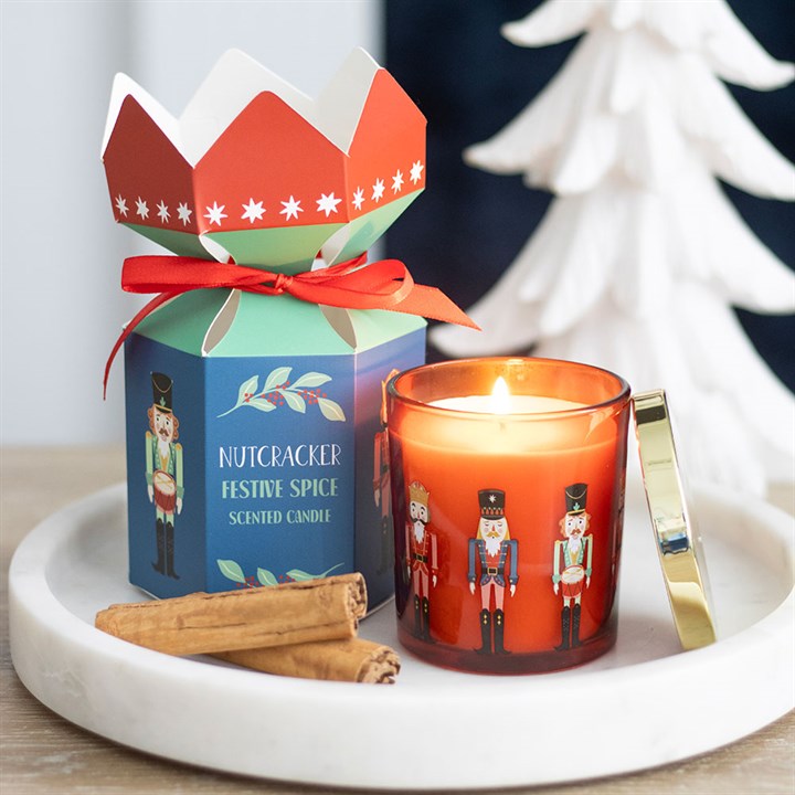Nutcracker Festive Spice Candle with traditional design, gold lid, and cinnamon sticks, perfect for seasonal gifting.
