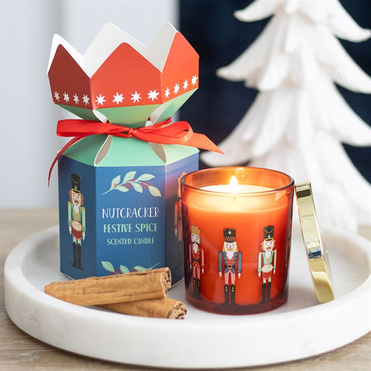 Nutcracker Festive Spice Candle with traditional design, gold lid, and cinnamon sticks, perfect for seasonal gifting.