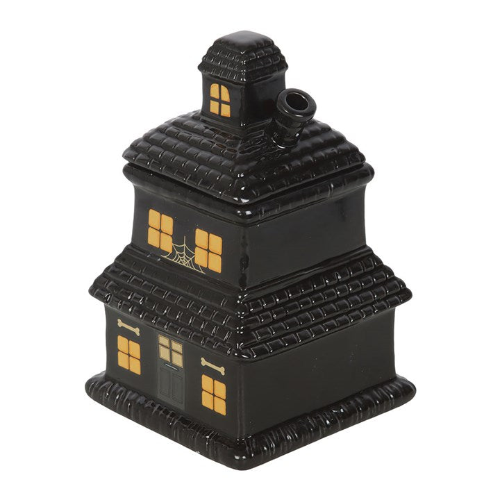 Black haunted house oil burner and wax warmer with glowing windows and spooky charm.
