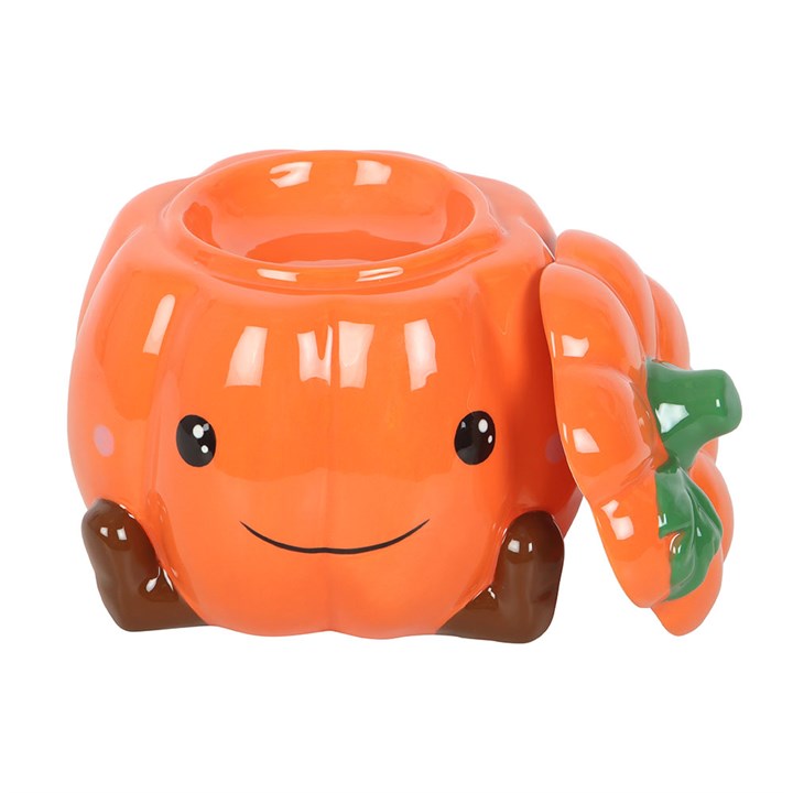 Cute ceramic pumpkin oil burner and wax warmer with a smiling face and green leaf