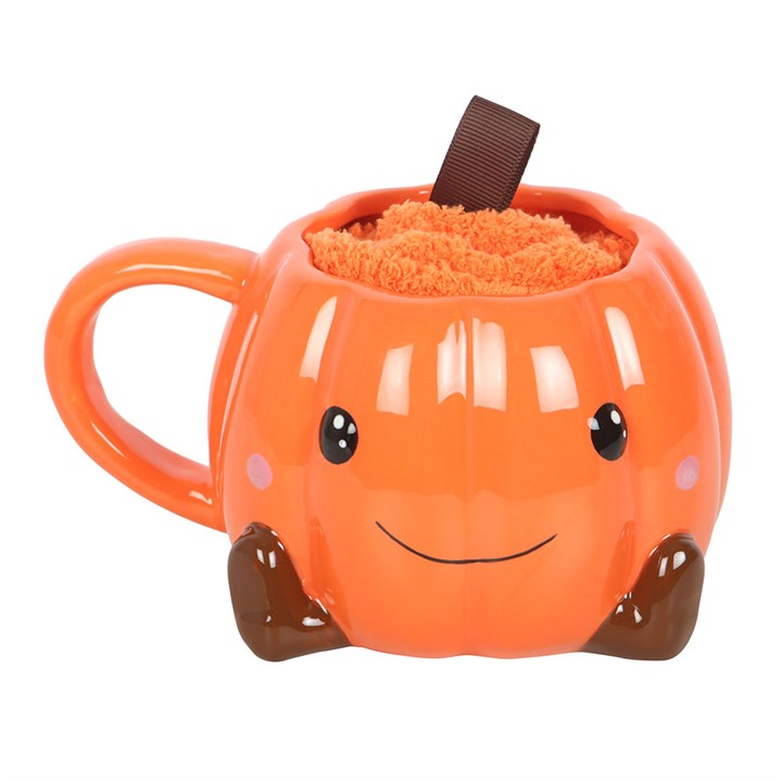 Cute smiling pumpkin mug in bright orange, cosy Halloween design.