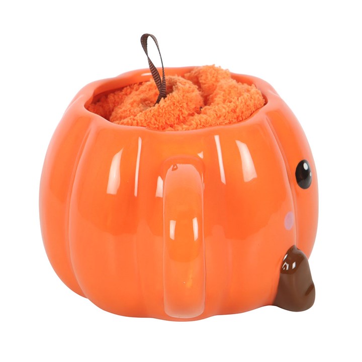 Cute smiling pumpkin mug with fluffy orange lining, part of a pumpkin mug and socks set.