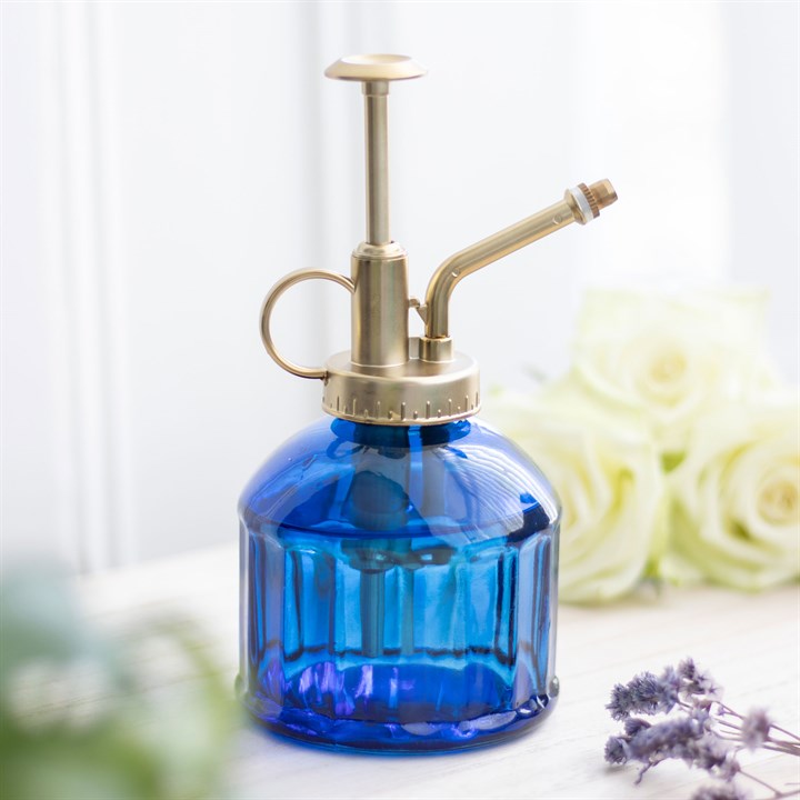 Small Blue Glass Plant Mister with vintage design and gold pump, ideal for indoor gardening enthusiasts.