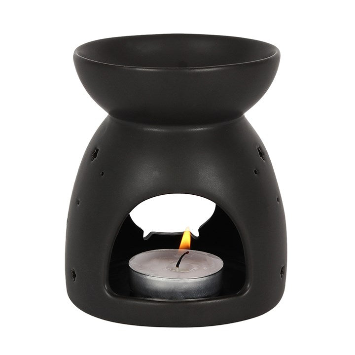 Black ceramic oil burner with a cauldron cut-out design and tealight inside.