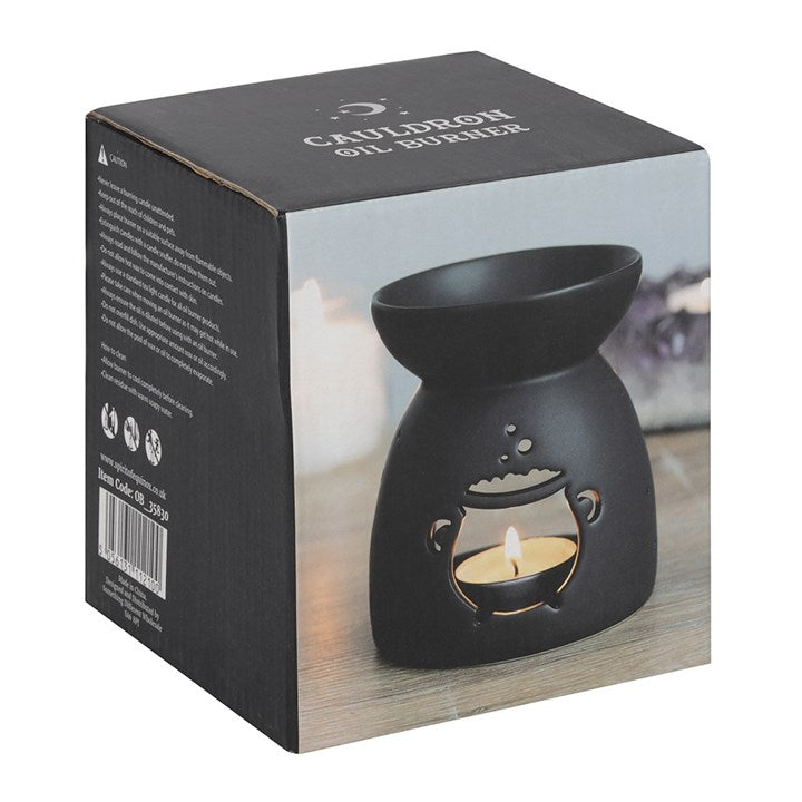 Black ceramic cauldron cut-out oil burner with a matte finish; candle visible inside.