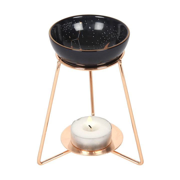 Purple star-sign oil burner on gold-coloured metal stand with constellation bowl and tealight
