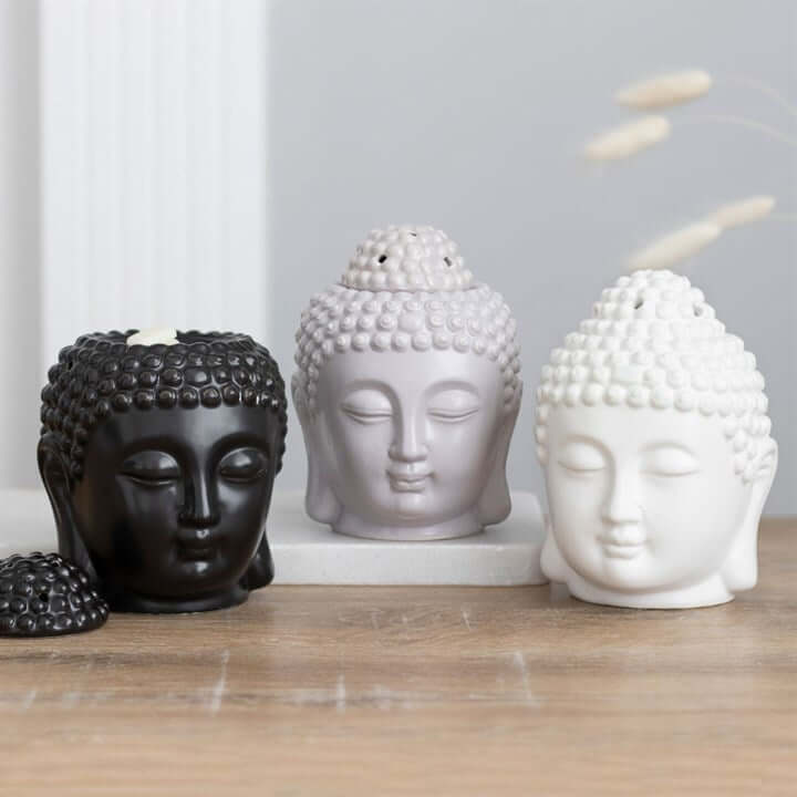 Black Buddha Head Oil Burner with matte finish, shown with grey and white Buddha head oil burners for serene ambience.